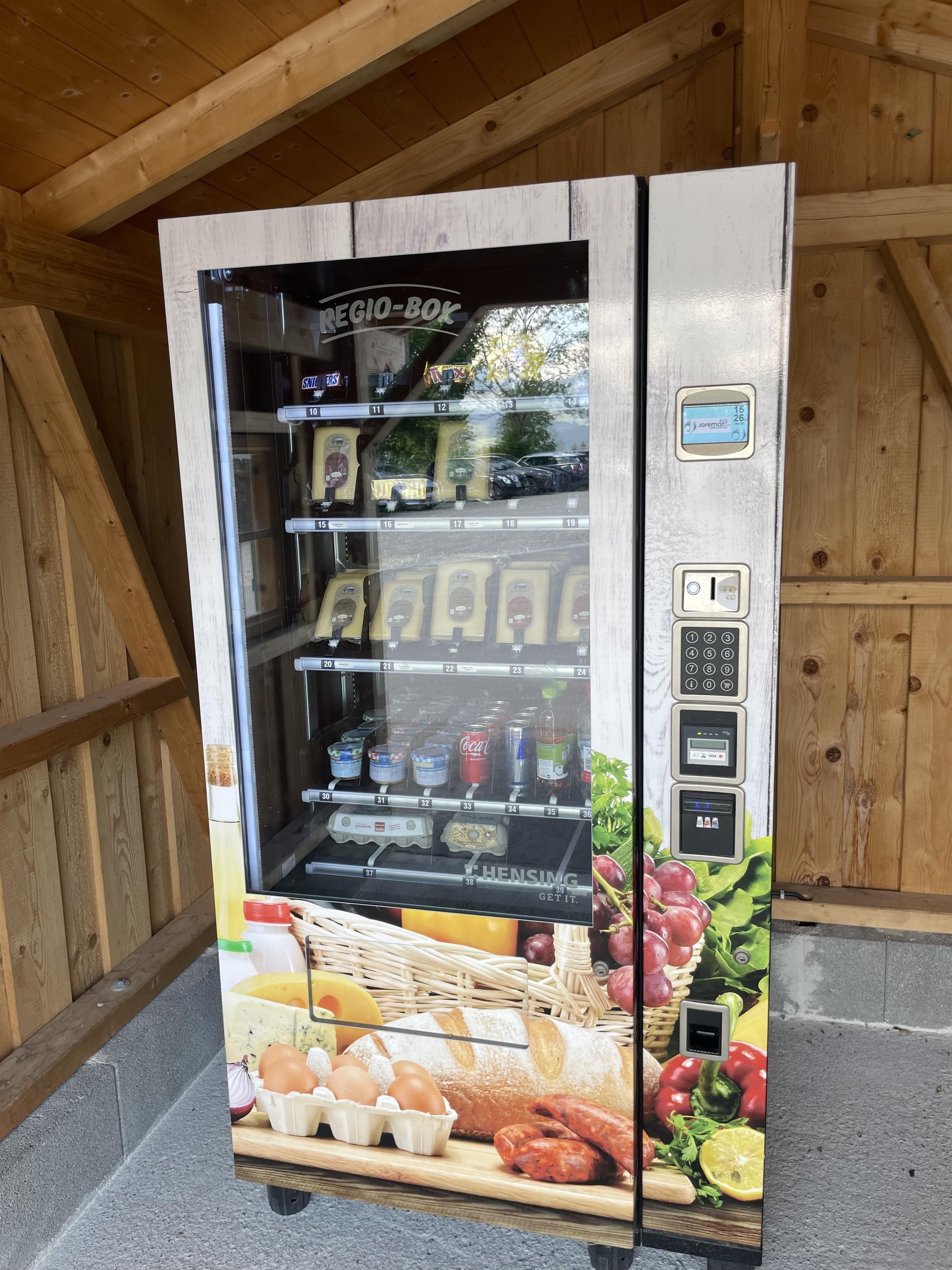 Lebensmittelautomat an der Schlitte Hitte in Ofterschwang, gefüllt mit regionalen Produkten: Käse, Wurst, Eier und mehr.