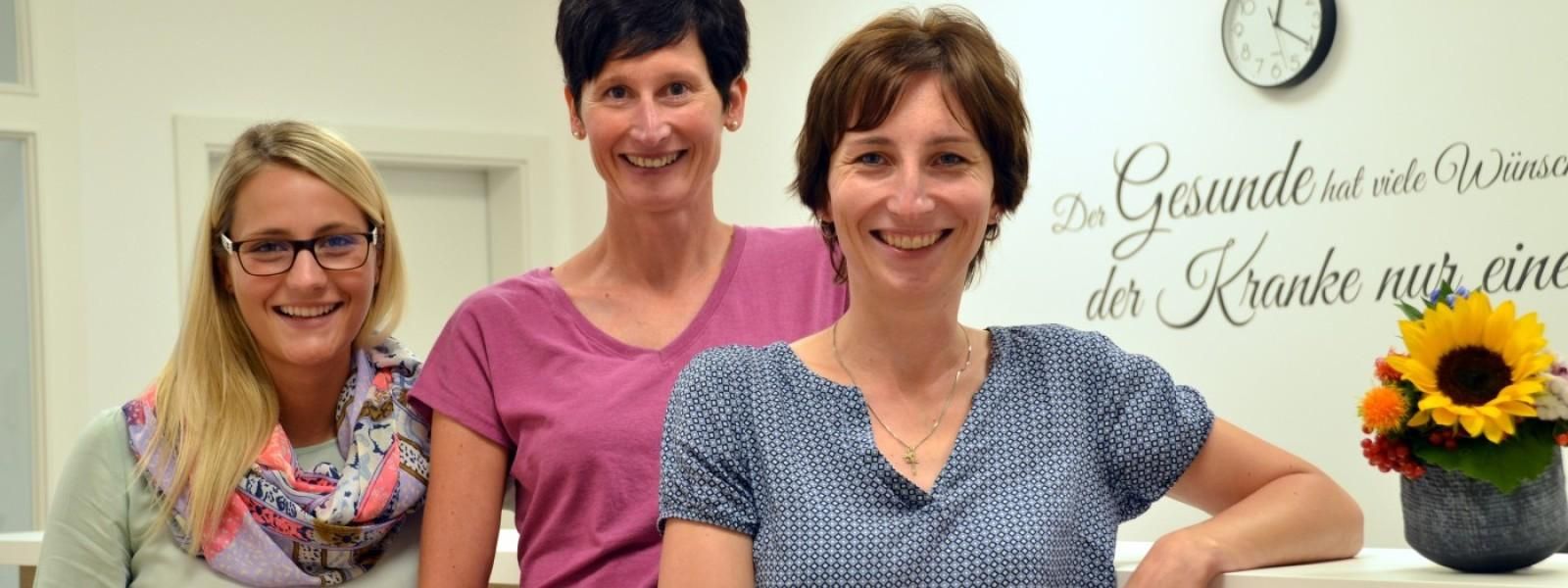 Ein Gruppenporträt zeigt Frau Dr. Sandra Stolz und ihr Team in ihrer Arztpraxis in Obermaiselstein.